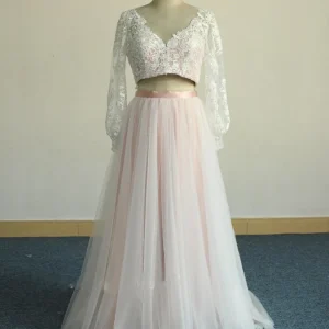 Roze tweedelige trouwjurk met lange mouwen en tule rok met witte kanten bovenlaag